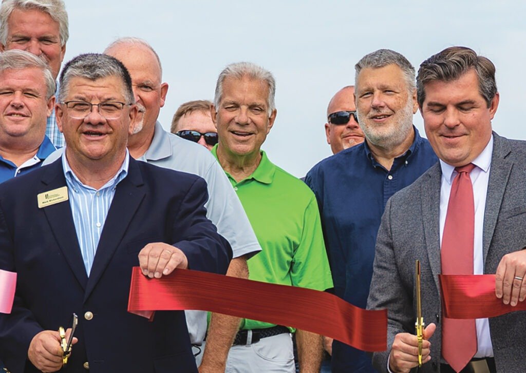 Huntington Mayor Richard Strick (right) and HCUED Executive Director Mark Wickersham (front left) cut the ribbon at the site of Teijin Automotive Technologies’ expanded facilities. | © HCUED